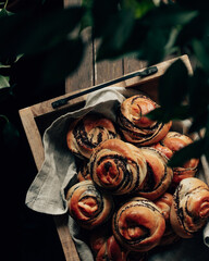baked buns with poppy seeds on a brown wooden board