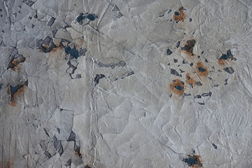 Background of old grey wall with cracks. Indoors at home