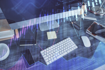 Double exposure of graph and financial info and work space with computer background. Concept of international online trading.
