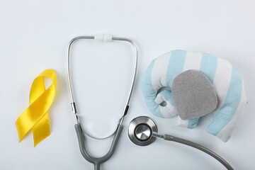 yellow ribbon symbolizing cancer in children top view
