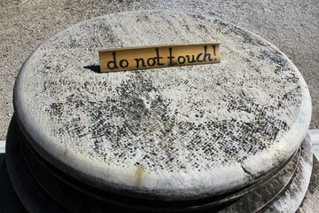 Greece, Athens, June 16 2020 - 'Do not touch' warning on the basis of ancient marble column at the...