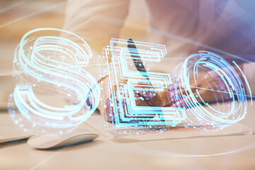 Man hands writing. With double exposure seo drawings.