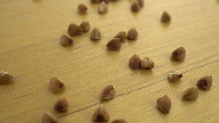 Buckwheat groats on a wooden surface. Macro shot of buckwheat.