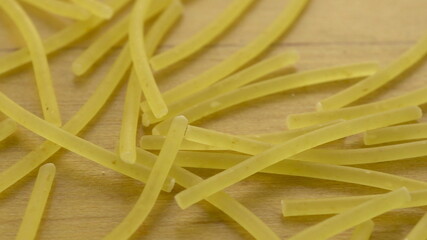 Noodles lie on a wooden surface. Pasta macro shot.