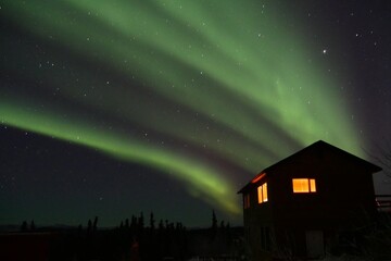 Strong green northern light over house in Fairbanks, Alaska