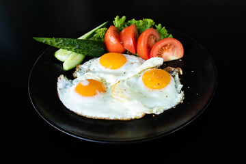breakfast of eggs, cucumbers and tomatoes