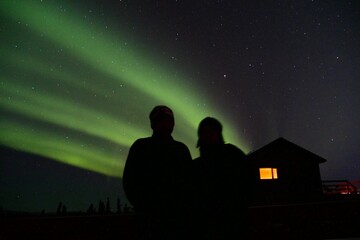 Silhouette of couple with norther light background in Fairbanks, Alaska
