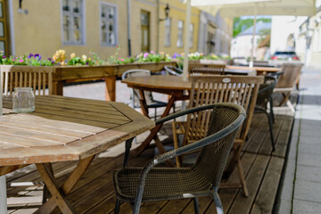 Fototapeta na wymiar Empty tables in street summer terrace cafe