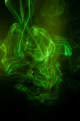 Green smoke motion on black background.