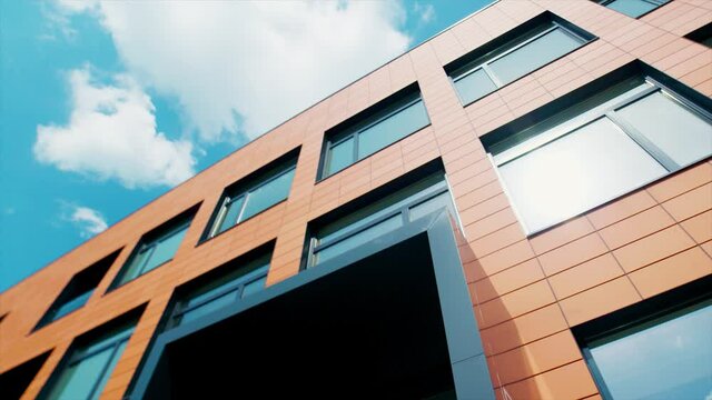 Aerial opening shot of an office building entrance. Low angle vibrant skyline
