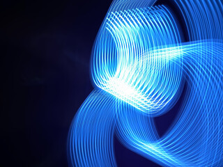 Beautiful graphic shapes made of light with a long exposure. Background pattern in shades of classic blue color of the year 2020.