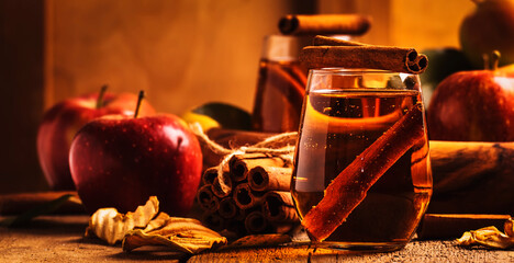 Hard Apple Cider Ale Ready to Drink. Cocktail with cinnamon, vintage wooden background