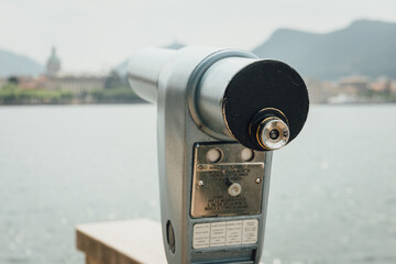 Lake Como coin operated monocular, looking on Como city on a cloudy day