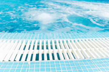 Swimming pool and blue water at the resort with beautiful sea view.