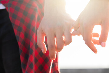 Couple holding hands with a pinky grip
