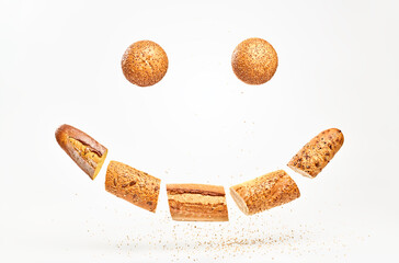 Baguette with sesame seed flying in air, smile shape. Fresh baked bread sliced, cut. Traditional bakery product french baguette. Wheat bread, levitation, fly food smile creative concept