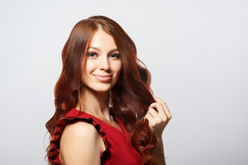 beauty portrait of a beautiful young woman with red curly hair.
