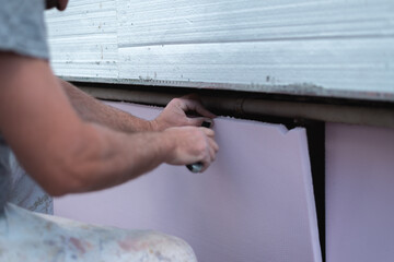 Worker cutting styro foam with precision knife