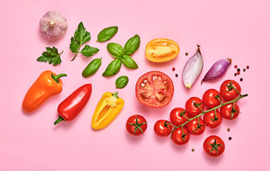 Tomato, basil, spices, bell chili pepper, garlic. Vegan diet food, creative composition on pink. Fresh basil, cherry tomatoes, bell pepper layout, cooking colorful concept, top view.