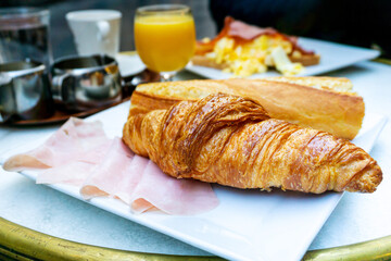 Breakfast with coffee and croissants on table