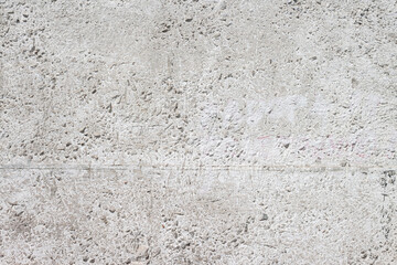 Obraz premium Concrete with rocks wall bumpy grey painted surface for cool urban grungy wallpaper or background