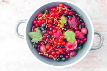mixed berries in a bowl on wooden table