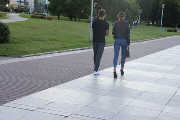 Fototapeta na wymiar couple in stylish dress walking at european street