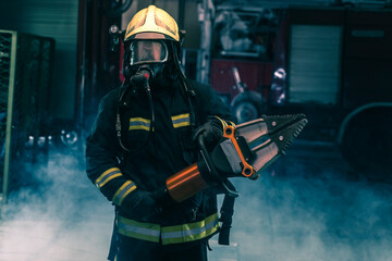 Portrait of a brave firefighter standing confident wearing full protective equipment, turnouts and...