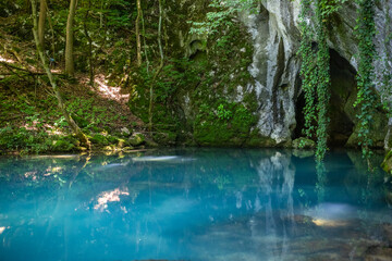 Obraz na płótnie Canvas Krupajsko Vrelo (The Krupaj Springs) in Serbia, beautiful water spring with waterfals and caves. Healing light blue water.