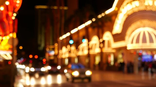 Defocused fabulous Las Vegas Strip boulevard, luxury casino and hotel, gambling area in Nevada, USA. Nightlife and traffic near Fremont street in tourist money playing resort. Neon lights of sin city.
