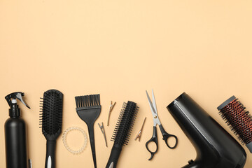 Composition with hairdresser accessories on beige background, space for text