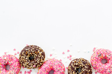 Donuts flat lay pattern on white background, top view