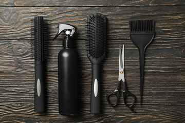 Flat lay with hairdresser accessories on wooden background