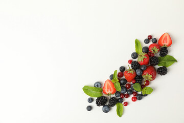 Fresh berries with mint leaves on white background, top view