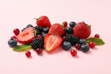 Mix of fresh berries on pink background, close up
