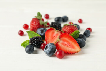 Mix of fresh berries on wooden background, close up