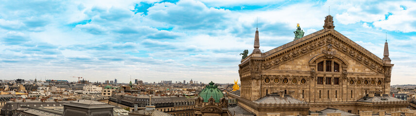 Eiffel Tower Amidst Buildings In City Against Cloudy Sky.