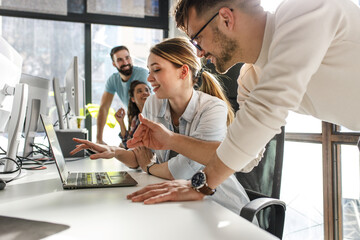 Group of team workers and programmers starting a new project.Senior programmer giving help to...
