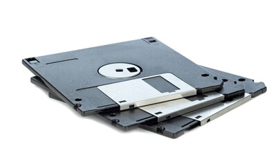 A small pile of 3.5 inch computer floppy discs lying on a white background