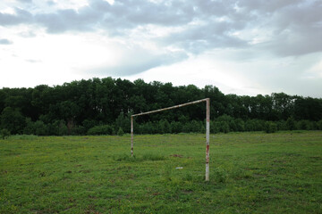 Football goal post in the middle of a poor quality pitch used for amateur games in rural Romania