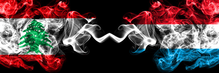 Lebanon vs Luxembourg smoky mystic flags placed side by side. Thick colored silky abstract smoke flags.
