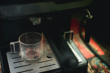 Espresso pouring from coffee machine.