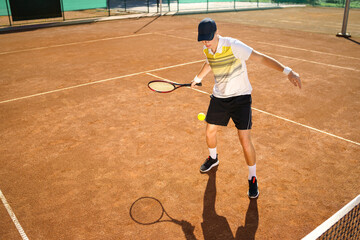 Young tennis player hitting the ball