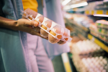 Close-up woman buys chicken eggs