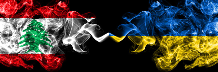 Lebanon vs Ukraine, Ukrainian smoky mystic flags placed side by side. Thick colored silky abstract smoke flags.