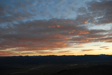 Dramatic sky cluds. Orange lenticular cluds. Sunset. South Patagonian sky.