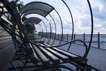 covered benches by the sea