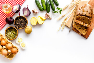 Above view of country dinner table with effs, bread, potatoes