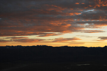 Dramatic sky cluds. Orange lenticular cluds. Sunset. South Patagonian sky.