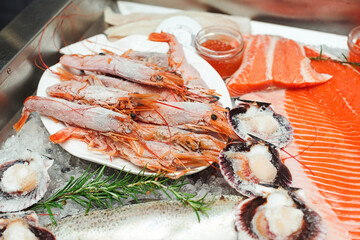 Showcase with shrimp and chilled red fish in grocery store. Market place, showcase with sea food. Retail sale, marketplace.
